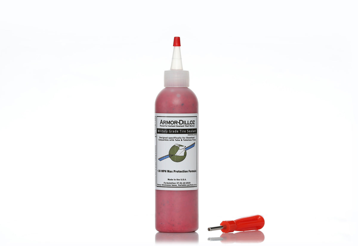 Red Armor-Dilloz tire sealant, 8 oz bottle with a red-handled valve-core tool