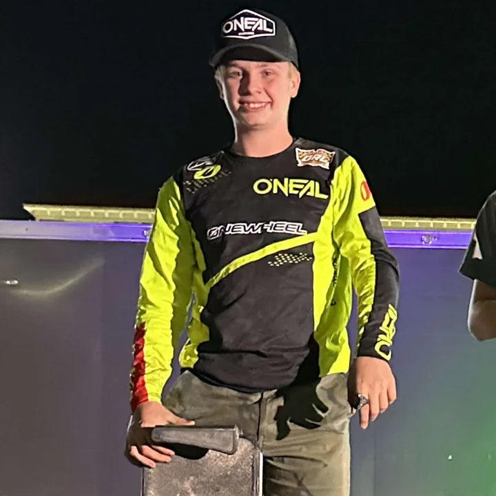 James O'Neal in his racing jersey with his Onewheel.