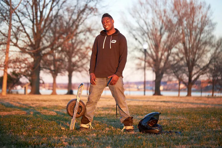 Javier Starks standing with his Onewheel.