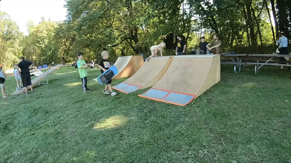 Race at the Ranch attendees gather around wooden ramps on the grass course.