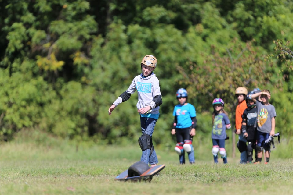 A helmeted rider carves across an open dirt track at Floatlife Fest 4.