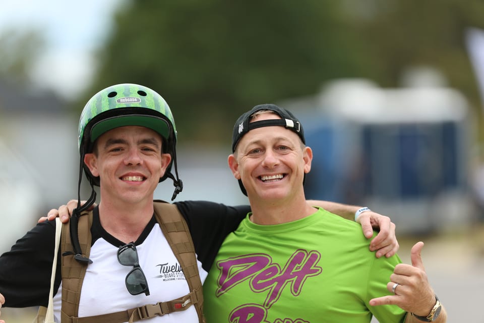 Two smiling helmeted riders stand together at Floatlife Fest 5.