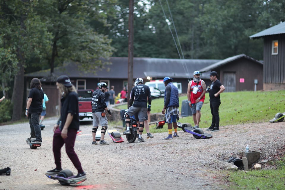 Riders gather near the wooded Floatlife Fest cabins before heading out.