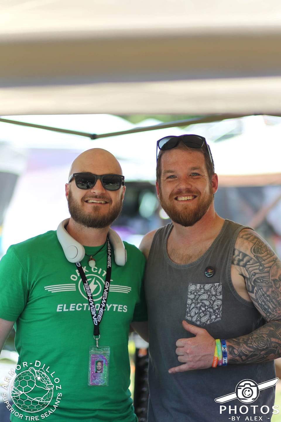 Two smiling attendees stand shoulder to shoulder at Oak City Shredfest.