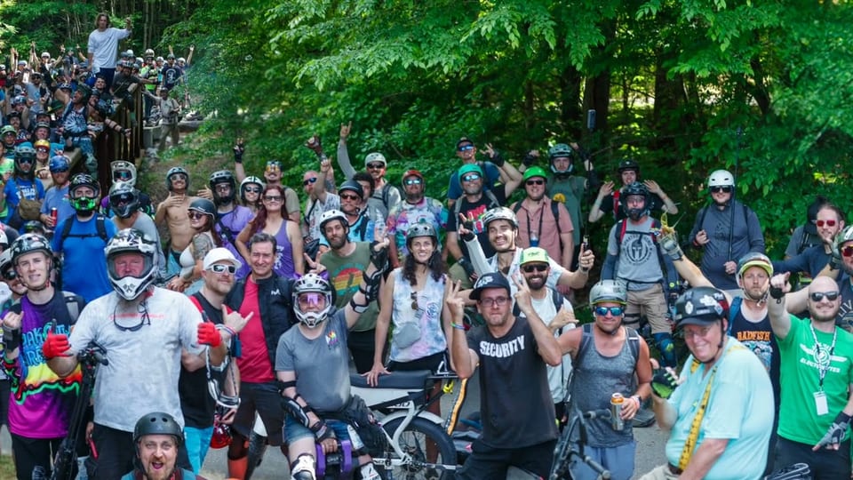 Oak City riders gathered in the bridge-group video still.