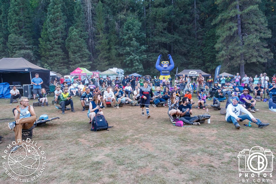 A large crowd of riders gathers outdoors for a Seek N' Shred awards photo.