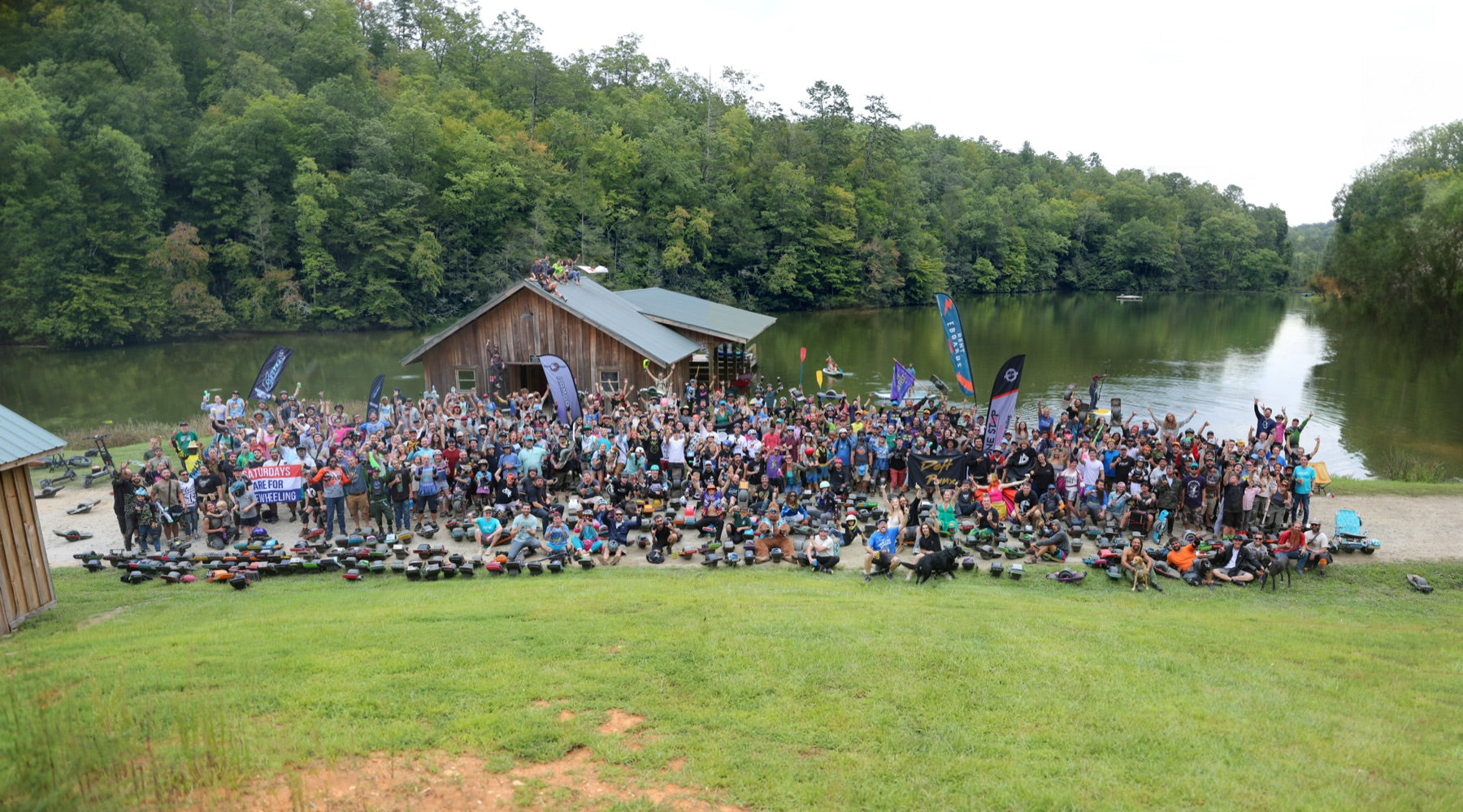 Floatlife Fest riders and their Onewheels gathered beside the lake.
