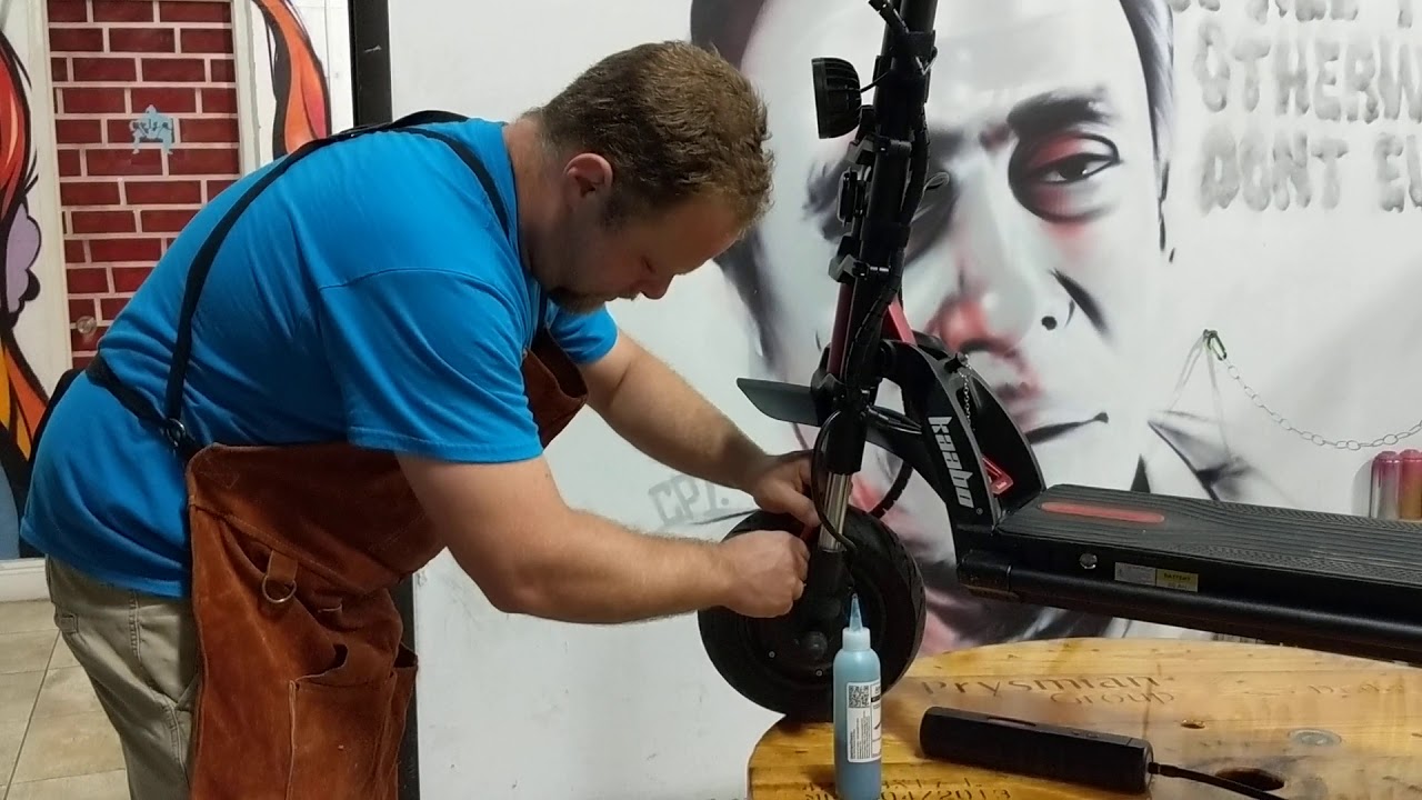 Cory preparing the valve on a Kaabo Wolf Warrior scooter tire
